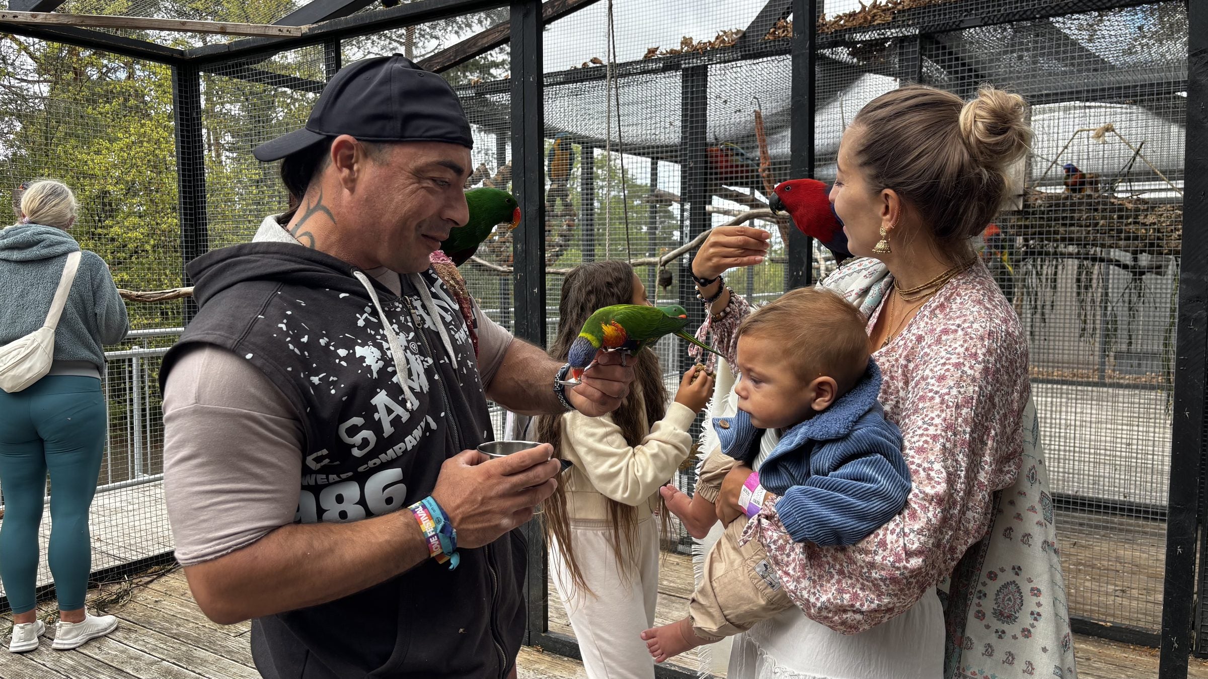 A family meeting lorikeets during a visit at Śuka