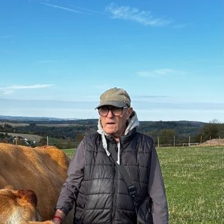 Girikumar Ananda with a cow on the pasture