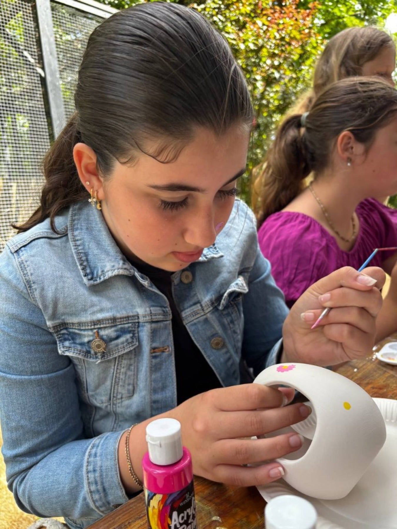 A young participant painting enrichment for the animals